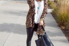 With white loose shirt, wide brim hat, leather pants, tote bag and beige ankle boots