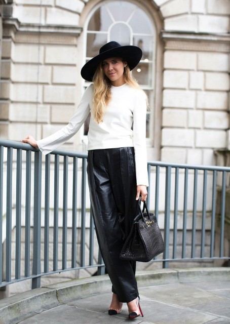 With white shirt, black wide brim hat, black bag and high heels