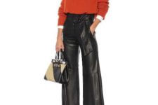 With white shirt, orange sweater, two colored bag and black mules