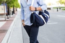 a blue shirt, navy joggers, blue and navy trainers, a navy sport bag for a comfy fall outfit