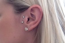 a double microdermal piercing next to the tragus is a unique idea to accent the ears