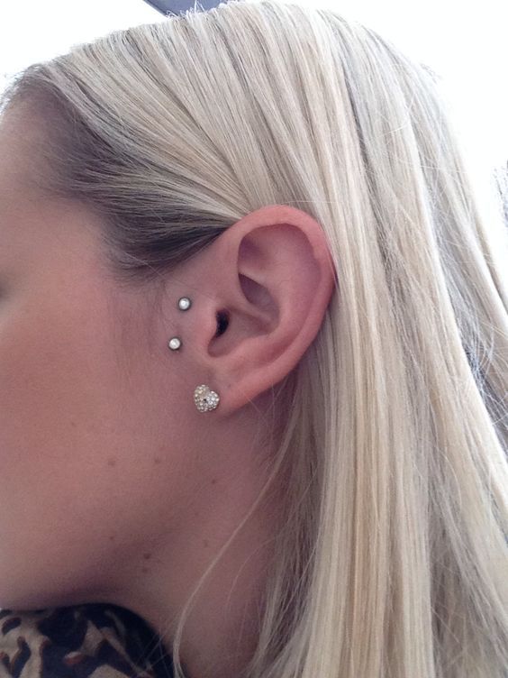 a double microdermal piercing next to the tragus is a unique idea to accent the ears