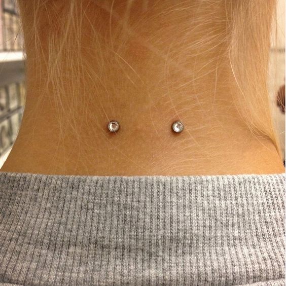 a double microdermal piercing on the back of your neck is a creative idea to try