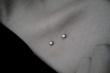 a double microdermal piercing under the collarbone to highlight your beauty