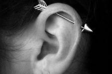 a horizontal industrial piercing done with an arrow is a fun and whimsy idea with a boho feel