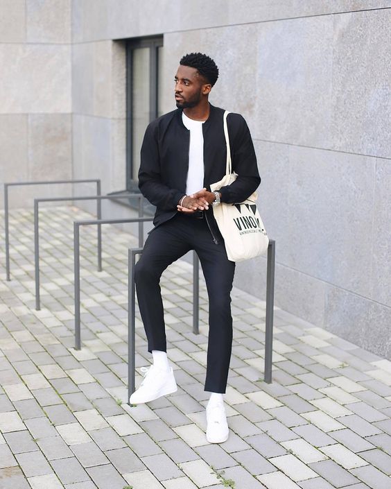 a navy bomber jacket, navy pants, a white tee, white sneakers and a tote for a laconic fall look