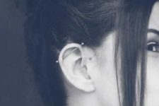 a single vertical industrial piercing and nothing else make the look very laconic yet eye-catchy