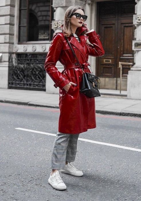 a striped top with long sleeves, grey checked pants, white sneakers, a red lacquered coat, a black bag