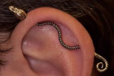 a very creative industrial piercing done with a snake bar will make your look unique