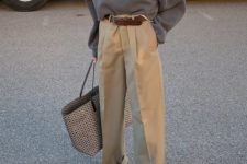 a white tee, a graphite grey oversized jumper, tan oversized pants, beige shoes and a printed bag