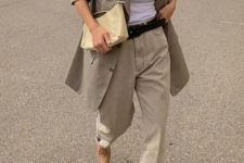 a white top, neutral oversized pants, a taupe oversized blazer, beige shoes and a neutral clutch