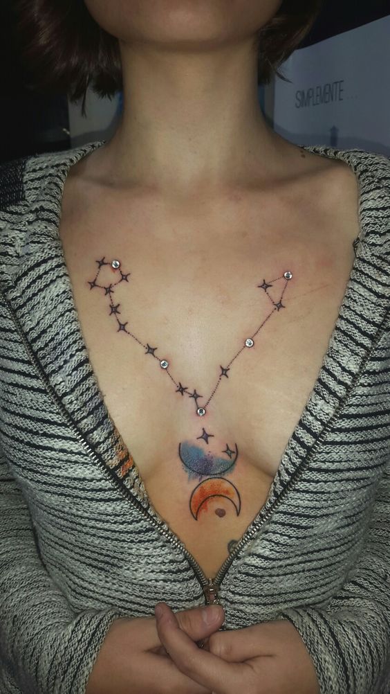 highlighting a cool constellation tattoo with severla dermal piercings is a bold solution