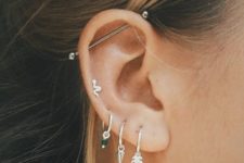 multiple ear piercings in the lobe and helix and an industrial bar for a bold look