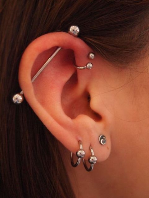 three lobe piercings, a helix one and an industrial one done with the similar accessories