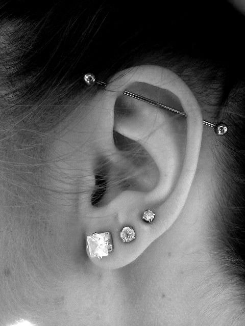 three lobe piercings paired with a single horizontal industrial one make your ear outstanding