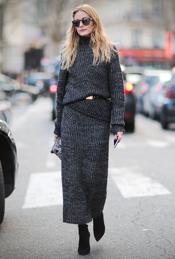 a black knit suit with a maxi skirt and a turtleneck sweater, black booties and a belt by Olivia Palermo