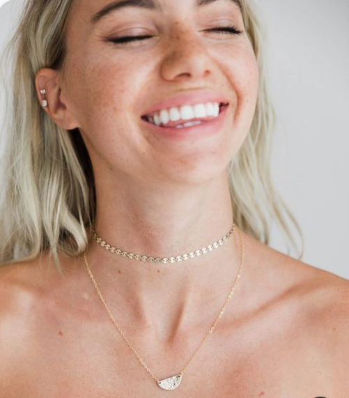 a delicate chain choker necklace paired with a more delicate one with a pendant for a relaxed and boho look