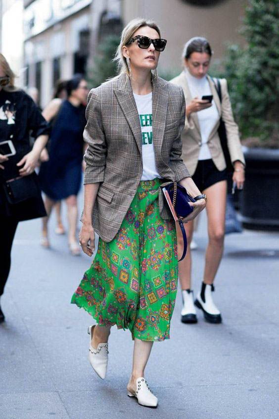 a printed tee, a bright printed green midi, white slip mules and a plaid oversized blazer