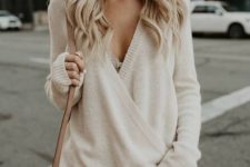 14 a simple and sexy outfit with blue ripped jeans, a creamy V cut sweater with a lace bralette and a beige bag