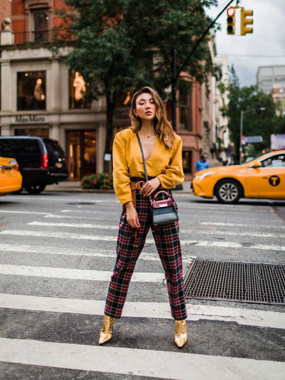 a yellow shirt, plaid pants, metallic gold booties and a two tone mini bag for a bold and sexy look