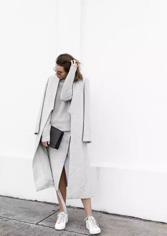an elegant knit grey suit with a long sleeve top and a midi wrap skirt, a grey coat and white sneakers