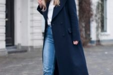 17 a casual outfit with a white top, blue jeans, navy loafers and a navy straight coat for more comfort