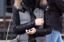 24 a padded jacket that imitates wool and features black sleeves and faux fur