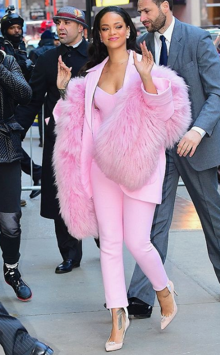 Rihanna wearing a hot pink faux fur coat to match her suit looks just wow