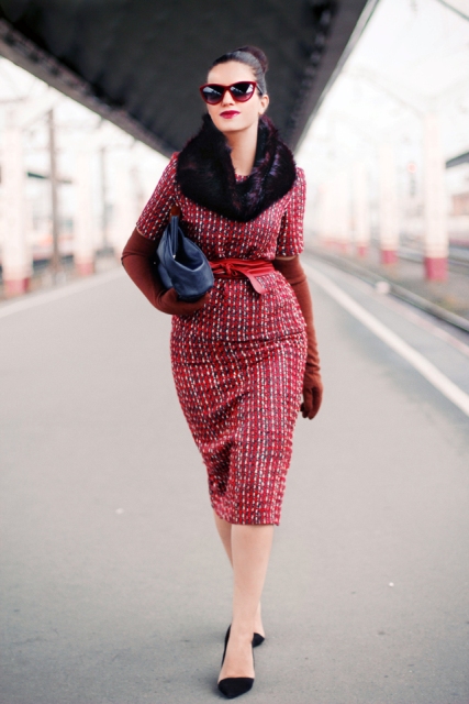 With black bag, black flat shoes and red tweed jacket with fur collar and belt