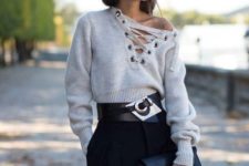 With black high-waisted trousers, black leather clutch and embellished belt