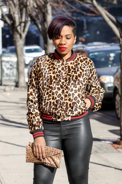 With black leather pants and leopard clutch