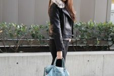 With black pants, white ankle boots and light blue bag