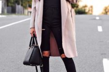 With black top, distressed pants, ankle boots and black bag