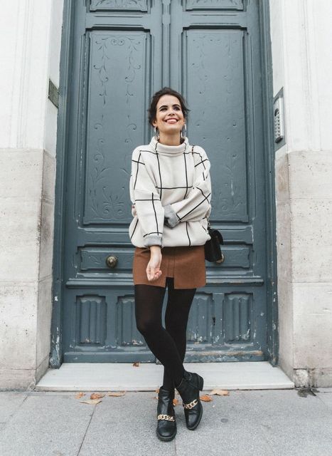 With brown mini skirt, black tights, black bag and embellished boots