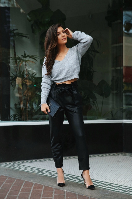With gray cropped sweater, black leather clutch and black pumps