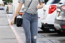With gray t-shirt, distressed skinny jeans, white sneakers and black crossbody bag
