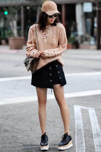 With lace up sweater, lace up mini skirt, platform shoes and chain strap bag