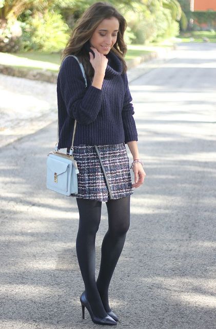 With loose sweater, light blue bag, black tights and black pumps