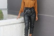 With orange blouse and black pumps