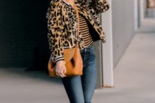 With striped shirt, skinny jeans, brown leather bag and sneakers