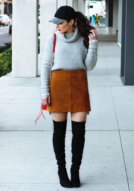 With sweater, brown suede mini skirt, red bag and black over the knee boots