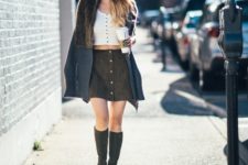 With white cropped top, oversized scarf and high boots