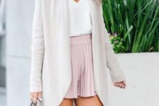 With white top, pale pink pleated shorts and light gray bag