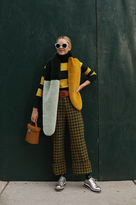 a bright look with a striped yellow and black turtleneck, plaid pants, silver shoes and a shawl that matches