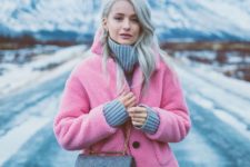 a chic and comfy winter look with a grey sweater, blue jeans, a pink faux fur coat and a grey studded box bag