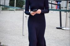 a chic winter look with an A-line knit black midi dress with a turtleneck and long sleeves plus blakc boots