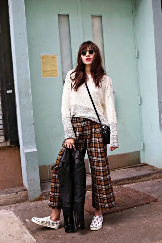 a creative outfit with a neutral long sleeve top, plaid cropped pants, printed slipons and a black leather jacket