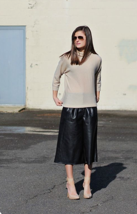 a minimalist look with a tan turtleneck, black leather culottes and tan ankle strap shoes