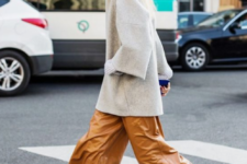 a minimalist look with an oversized gren sweater, amber leather culottes, black and sheer shoes