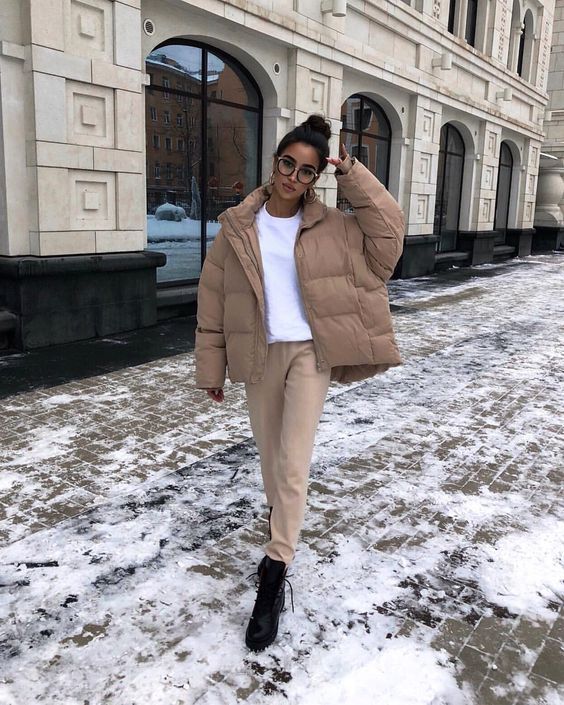 a simple outfit with a white tee, camel pants, black boots, a camel puffer jacket for a cold day